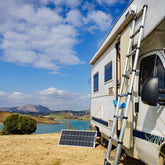 RV with a portable solar panel setup, ideal for those looking to expand their off-grid power options with add-on solar kits